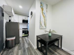 a kitchen with a black table and a refrigerator at VibeHaus Midtown in New York +6 photos
