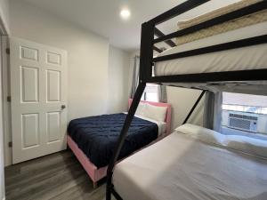 a bedroom with two bunk beds and a door at VibeHaus Midtown in New York
