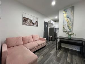a living room with a pink couch and a piano at VibeHaus Midtown in New York