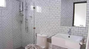 a white bathroom with a toilet and a sink at Sabai @ Chiang Rai in Chiang Rai +211 photos