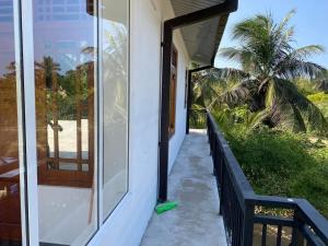 a porch of a house with a mop at Naren Guest House in Kallady