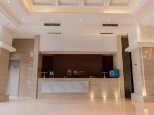 a lobby with a reception desk in a building at Jinjiang Inn Select Hohhot Chengjisihan Square Metro Station in Hohhot