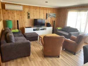 a living room with two couches and a television at 41 Bailey Rd - Family - Surf Beach - No Linen Included in Middleton