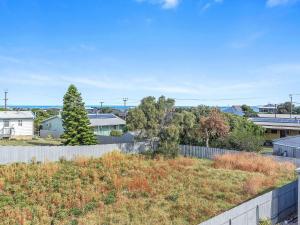 a yard with a fence and trees and houses at 41 Bailey Rd - Family - Surf Beach - No Linen Included in Middleton