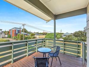 a patio with two chairs and a table on a deck at 41 Bailey Rd - Family - Surf Beach - No Linen Included in Middleton +14 photos