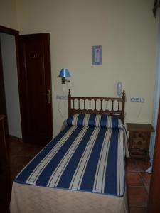 Ένα ή περισσότερα κρεβάτια σε δωμάτιο στο Hostal Casais