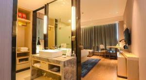 ein Badezimmer mit einem Waschbecken und ein Wohnzimmer in der Unterkunft Echarm Hotel Xian Ming City Wall South Gate in Xi'an + 181 Fotos