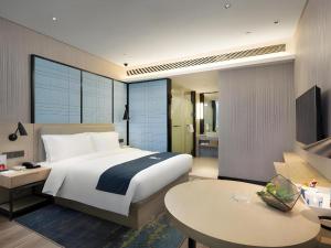 Ένα ή περισσότερα κρεβάτια σε δωμάτιο στο Echarm Hotel Changsha Gaoqiao