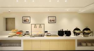 a kitchen with a buffet of food on a counter at City Comfort Inn Guiyang North High Speed Railway Station in Guiyang