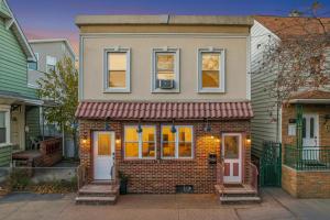 a brick house with a red awning at Hamilton in Harrison