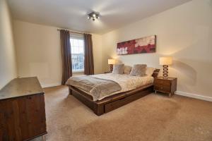 a bedroom with a large bed and a window at Edinburgh Pearl Apartments - Haymarket Residence in Edinburgh