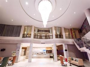 a large lobby with a spiral staircase in a building at City Comfort Inn Lingshui Central Avenue Bus Station in Lingshui