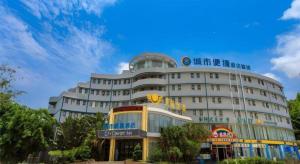 a large building with a sign in front of it at City Comfort Inn Lingshui Central Avenue Bus Station in Lingshui