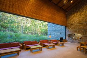 a large room with couches and a fireplace at BUB RESORT Yatsugatake in Hokuto