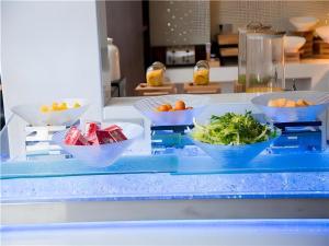 three bowls of food on a counter in a kitchen at Borrman Hotel Huanggang Wuxue Yuhu Road in Wuxue