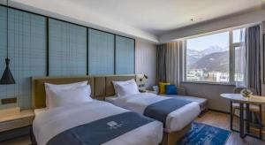 Postel nebo postele na pokoji v ubytování Echarm Hotel Tai'an Taishan Tianwai Village Hongmen + 232 fotografií