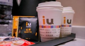 two cups of coffee sitting on a tray with food at IU Hotel Suizhou Shunjing Avenue Passenger Transportation Center in Suizhou