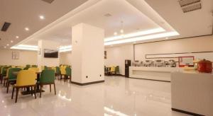 a waiting room with chairs and tables in a hospital at Green Tree Inn Nanchang Zhongshan Road Bayiguan in Nanchang