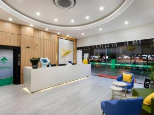 a lobby with a reception desk and blue chairs at GreenTree Inn Express Fujian Ningde Ningchuan Road Qinghua Building in Ningde