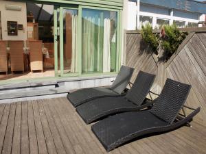 two black chairs sitting on a deck at Villa in Middelkerke near the Beach in Middelkerke +43 photos