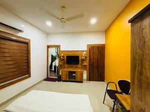 Una televisión o centro de entretenimiento en Ashirvad Avenue