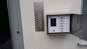 a wall with a door with a control panel at Paleo Finest Serviced Apartments in Munich