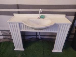 un fregadero blanco con un grifo sobre una mesa en Laqa comp Oman - مخيم لقى عُمان, 