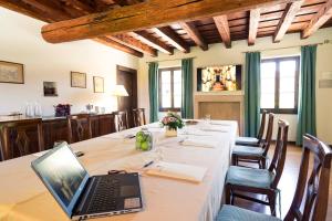 a table with a laptop computer on top of it at La Foresteria Serego Alighieri in SantʼAmbrogio di Valpolicella