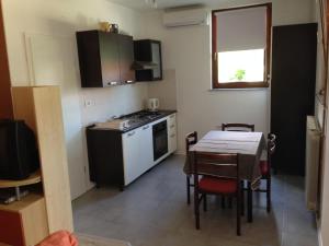 a kitchen and dining room with a table and a table and chairs at Apartma R Sport in Tolmin