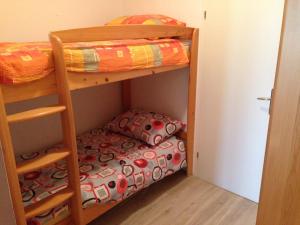 a bedroom with bunk beds and a small bed at Apartma R Sport in Tolmin