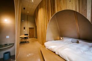 Postel nebo postele na pokoji v ubytování SANU 2nd Home 白樺湖2nd