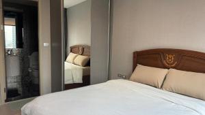 a bedroom with a bed and a large mirror at Modern Bangkok Apartment Train Access in Bangkok +12 photos