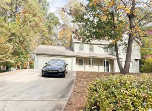 ein Auto, das in der Einfahrt eines Hauses geparkt ist in der Unterkunft King Bed Soaking tub, Yard with Screen Patio, Near ATL in Tucker