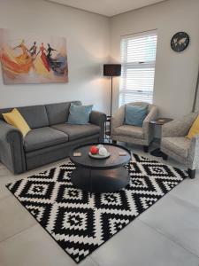 a living room with a couch and a table at Apartment 70 - 1 On York in George
