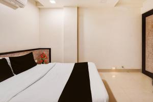 a bedroom with a bed with a christmas tree on it at Hotel O Vatva Railway Station Formerly Anmol Palace in Ahmedabad