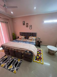 Un dormitorio con una cama grande y una mesa. en The Realm of ShivaShiv, en Rājpur