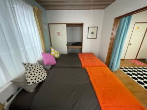 a large bed in a room with pillows on it at サイプレス平岸 in Sapporo