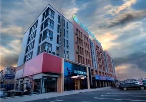 a building on a street with a parking lot at City Comfort Inn Hefei Wulimiao Feihe Road in Hefei