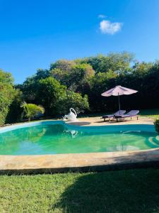 piscina con ombrellone e tavolo da picnic di 3 bedroom own compound house a Malindi