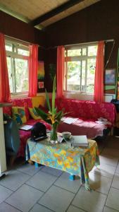 a living room with a couch and a table at Haut de Baie de Cook Moorea 6 nuits minimum in Paopao