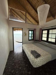 a bedroom with a bed in a room with a window at Blue Sky Resort in Ko Chang