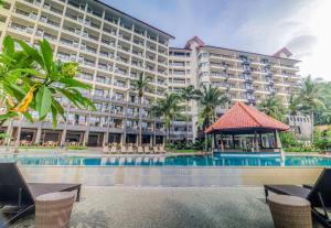 a large hotel with a pool and a gazebo at Laprima Hotel in Labuan Bajo