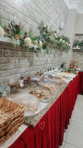 a long table with plates of food on it at Hotel seven park in Nevsehir