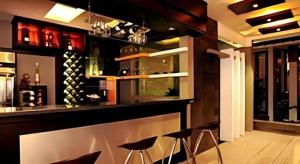 a bar in a wine cellar with stools at Savali Hotel in Kampungdurian