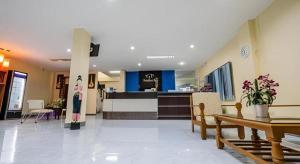 a lobby of a hospital with tables and chairs at Krabi Grand Place Hotel in Ban Khlong Chi Lat