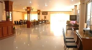 a large room with chairs and tables in a building at Chaleunehoung Hotel in Ban Houadông