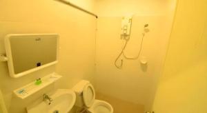 a bathroom with a shower and a toilet and a sink at Panita Resort in Ban Phang Phrao