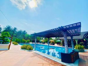 a swimming pool next to a resort with a swimming pool at Forever Green Resort in Ấp Nhứt (1)