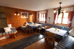 a living room with two tables and a couch at Kollerhof in Itter