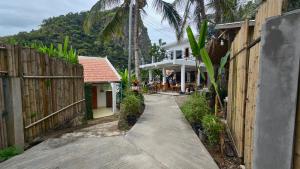a walkway leading to a house with a fence at My village river side in Nongkhiaw